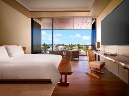 a bedroom with a bed and a flat screen tv at Nobu Hotel Palo Alto in Palo Alto