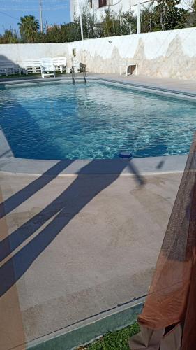a shadow of a person in a swimming pool at i girasoli srls in Bari