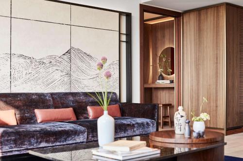 a living room with a couch and a table at Nobu Hotel Barcelona in Barcelona