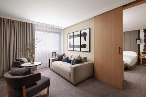 a hotel room with a couch and a bed at Nobu Hotel London Portman Square in London