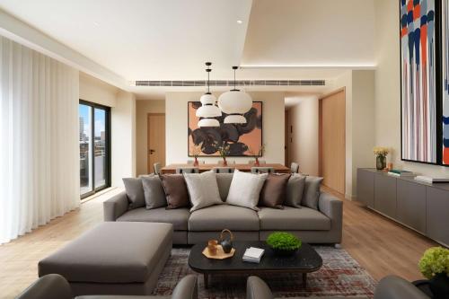 a living room with a couch and a table at Nobu Hotel London Portman Square in London