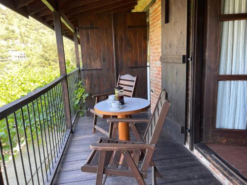 a table and two chairs on a porch at Ambelikos Traditional Agrohotel in Potamitissa