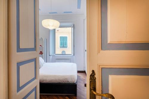 a small room with a bed and a window at Santa Chiara Apartment by Wonderful Italy in Genova