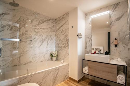 a bathroom with a tub and a sink at Best Western Plus Nice Cosy Hotel in Nice