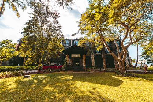 a park with a tree and a building at Taita Hills Safari Resort & Spa in Tsavo