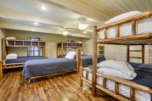 a bedroom with two bunk beds and wooden floors at Dularge Grand Villa - Steps to Marina and Fishing! in Theriot