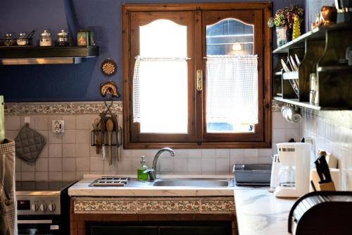a kitchen with a sink and a window at Villa Pigadi Nikiti beach vacation in Metamorfosi