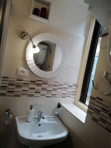a bathroom with a sink and a mirror at La casa di Cinzia in Pettorano sul Gizio