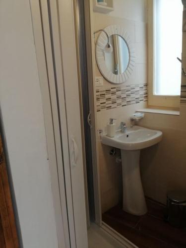 a bathroom with a sink and a mirror at La casa di Cinzia in Pettorano sul Gizio