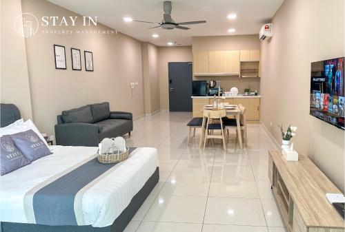 a bedroom with a bed and a living room at Atria Sofo Suites - Petaling Jaya in Petaling Jaya