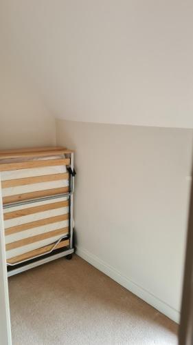 a corner of a room with a closet with a shelf at Narnia in Wem
