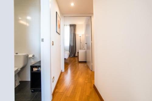 a hallway of a room with a sink and a toilet at 31TILB1041 Magnific Apartment in Villa Olímpica in Barcelona