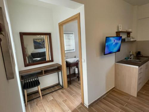 a bathroom with a mirror and a sink and a mirror at Tzovolos Apartments in Kalavrita