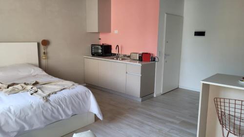 a bedroom with a bed and a kitchen with a sink at La Belle San Isidro Lofts in San Isidro