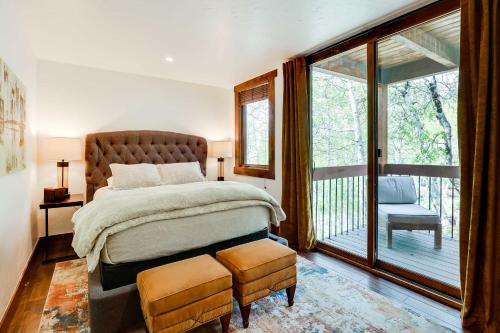 a bedroom with a large bed and a balcony at Elegant Vail Home - Walk to Booth Falls Trail in Vail