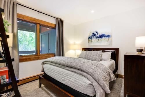 a bedroom with a bed and a window at Elegant Vail Home - Walk to Booth Falls Trail in Vail