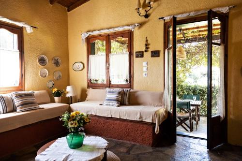a living room with two beds and a table at Villa Pigadi Nikiti beach vacation in Metamorfosi