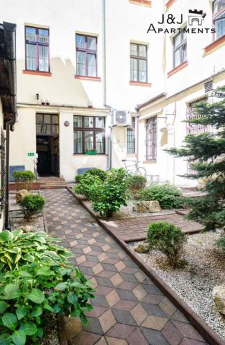 a stone walkway in front of a building at J&J Apartments Szeroka 25 Apartament 1 in Toruń