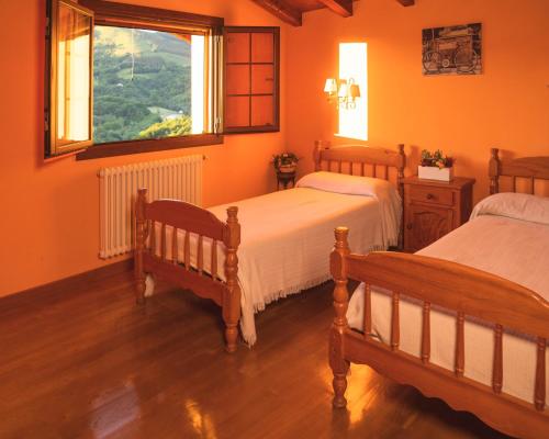 a bedroom with two beds and a window at LAIZARRONDO in Arantza