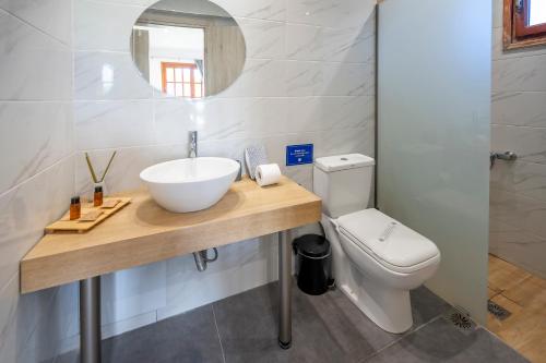 a bathroom with a sink and a toilet at Jonathan City Apartment in Kos Town