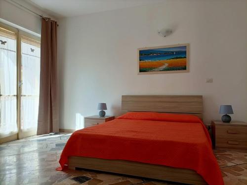 a bedroom with a red bed and a painting on the wall at Nice days in Pescara