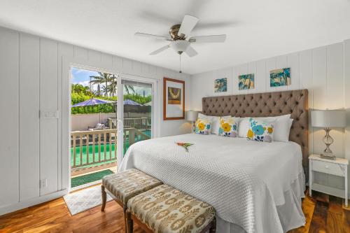 a white bedroom with a bed and a window at Emmalani 3BR Princeville Villa with Private Pool in Princeville