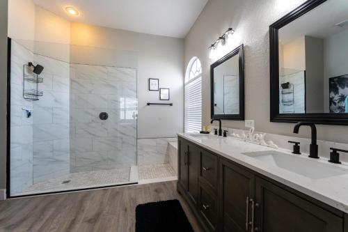 a bathroom with a shower and a sink and a mirror at bsv_villa424 in Davenport