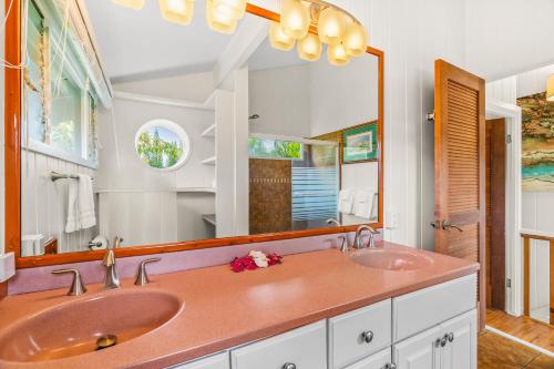 a bathroom with two sinks and a large mirror at Emmalani 3BR Princeville Villa with Private Pool in Princeville