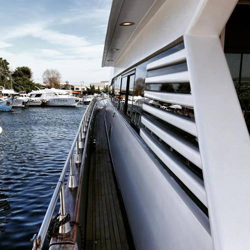 a boat on a river with boats in the water at Exclusive Yacht Stay - Best Sea & Old Town Views - Prime Location in Kavala