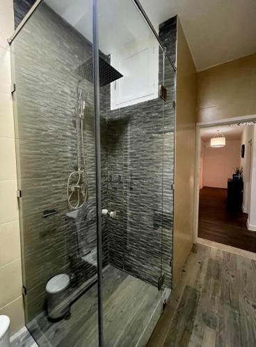 a shower with a glass door in a bathroom at Beach breeze in Essaouira
