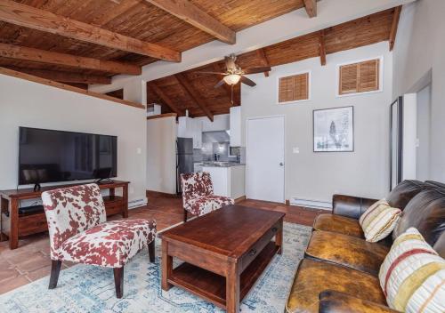 a living room with a couch and chairs and a tv at 2 BR Newly Renovated Waterfront Home; 10 min from MGM & the Gaylord in Fort Washington