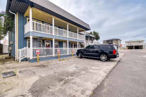 a black suv parked in front of a building at Steps to Ocean North Myrtle Beach Condo with Porch! in Myrtle Beach