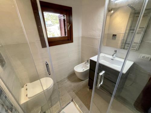 a bathroom with a toilet and a sink and a shower at SAN TEODORO PUNTA EST AMPIO TRILOCALE VISTA MARe in Capo Coda Cavallo
