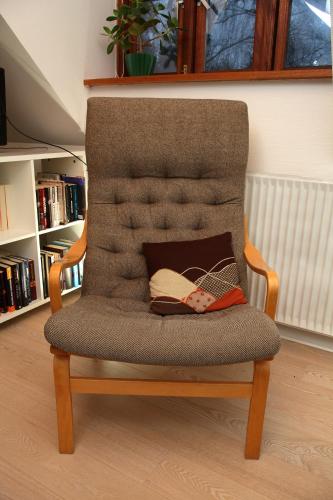 a chair with a pair of shoes sitting on it at Bed & Breakfast Horsens in Horsens