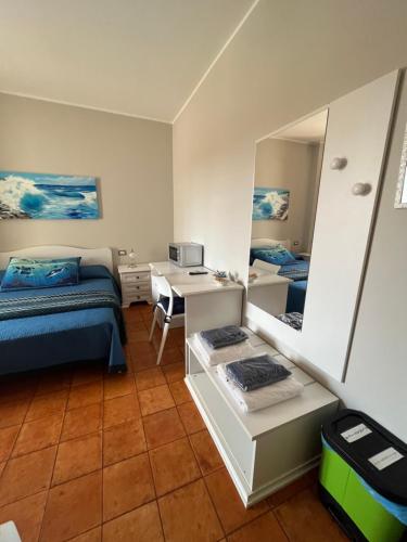 a bedroom with a bed and a desk and a mirror at Le Stanze di Lucia vicino Ospedale Cardinale Panico a Tricase in Tricase