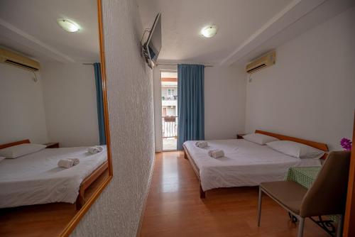 a bedroom with two beds and a mirror at Apartment Marcic in Bar