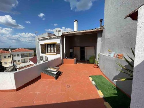 a balcony of a house with a patio at Casa 13 in Montargil