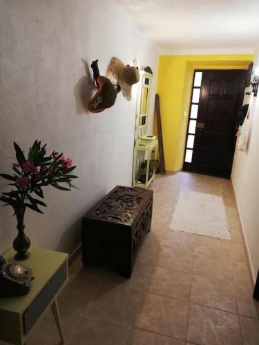 a hallway with a room with a table and a door at Casa 13 in Montargil