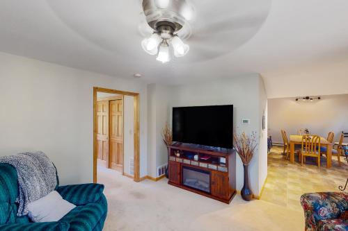 a living room with a flat screen tv and a couch at Mountain Escape in Sturgis