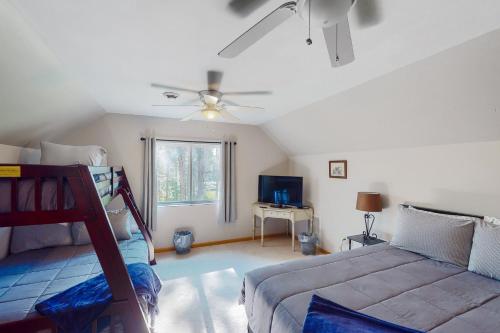 a bedroom with a bed and a ceiling fan at Mountain Escape in Sturgis