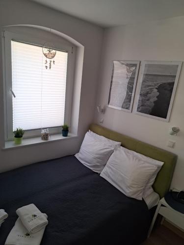 Ένα ή περισσότερα κρεβάτια σε δωμάτιο στο Apartamenty Via Mare
