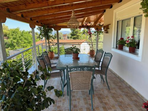 eine Terrasse mit einem Tisch und Stühlen auf dem Balkon in der Unterkunft Vaso's Paradise in Eretria