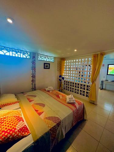 a bedroom with a bed and a window at CASA MOSAICO in Puerto López