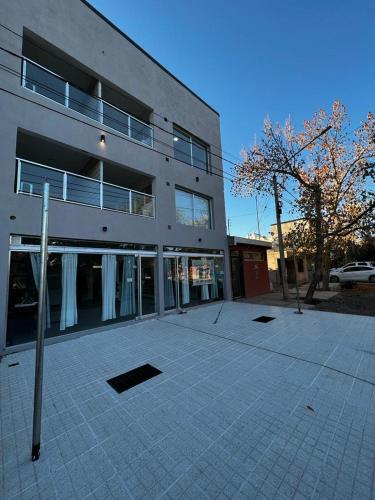 a large building with a parking lot in front of it at URIBURU 45 in Malargüe