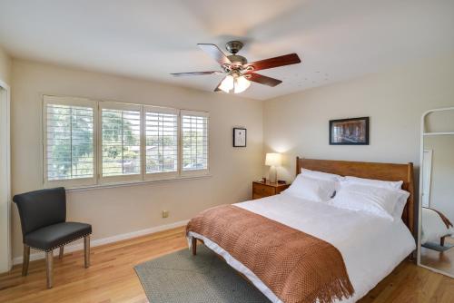 a bedroom with a bed and a ceiling fan at Charming San Jose Home with Covered Patio and Backyard in San Jose