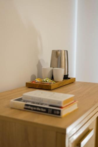 a table with two books and two cups on it at Hotel Club-E in Fethiye