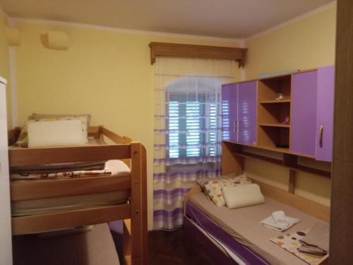 a small room with a bunk bed and a window at Centar Starog Grada in Kotor