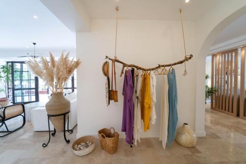 a room with clothes hanging on a wall at Hotel Club-E in Fethiye