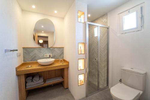 a bathroom with a sink and a toilet and a mirror at Hotel Club-E in Fethiye
