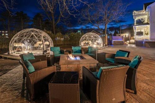 a patio with a fire pit and gazebos at night at Lakehurst Estate in Cobourg